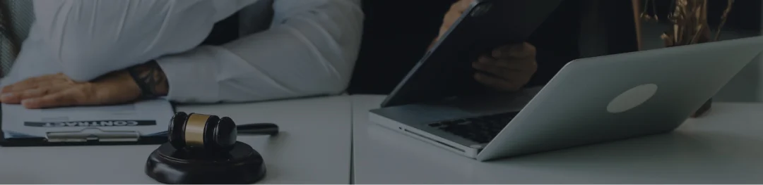 A lawyer's desk featuring a laptop and a phone, symbolizing a professional workspace for legal work.