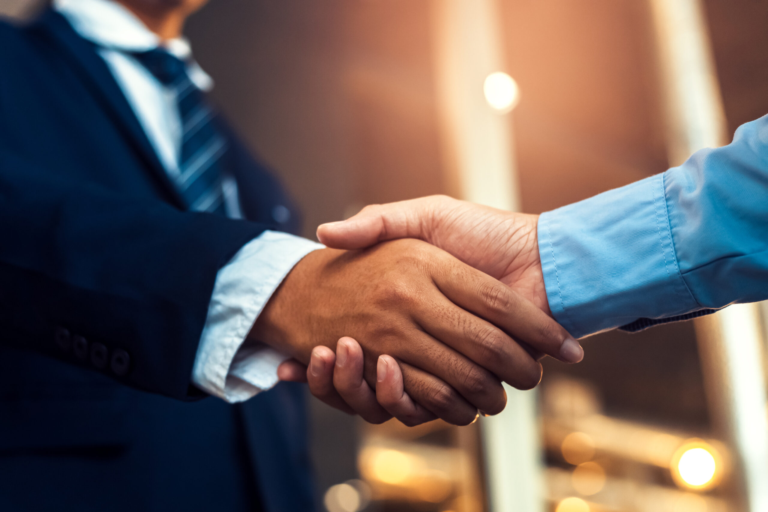 handshake between two people dressed formally