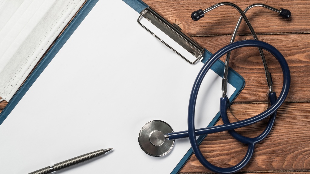 Doctors wooden table with tablet stethoscope