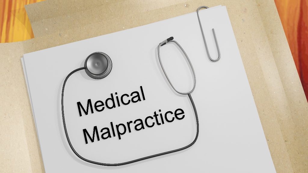 A stethoscope on medical document, titled Medical Malpractice