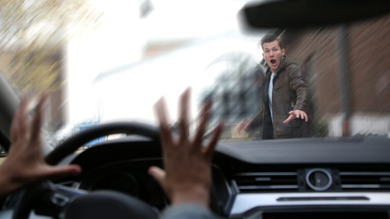 young male pedestrian has an accident with a car