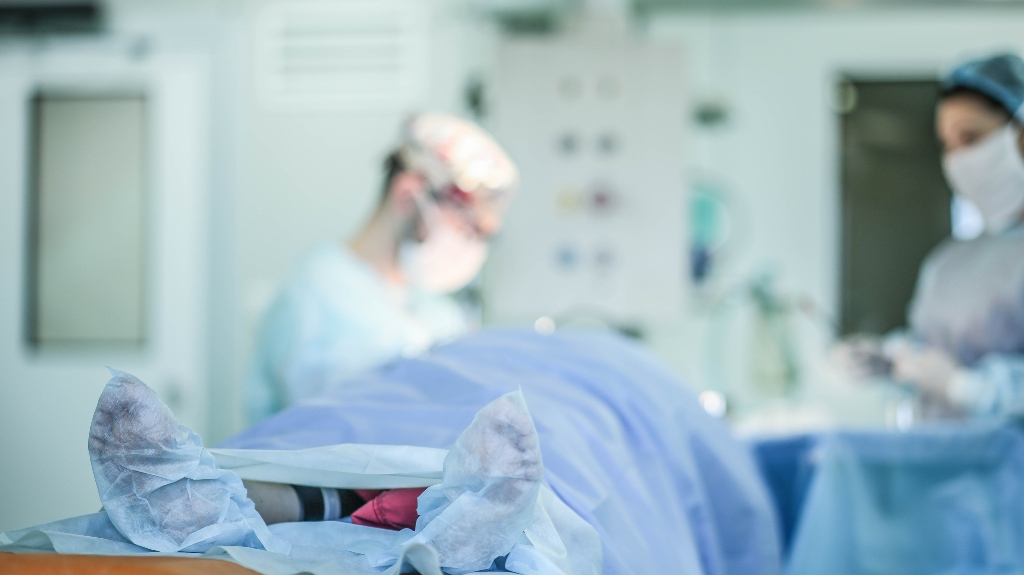 Patient's feet on the background of surgery