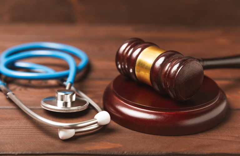 stethoscope and hammer on a desk
